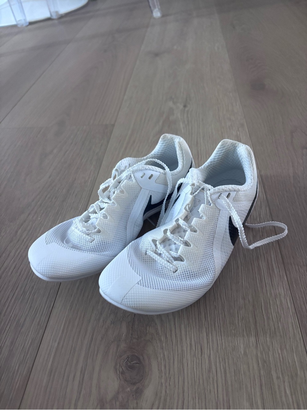 Nike white with black swoosh track and field multi event spikes